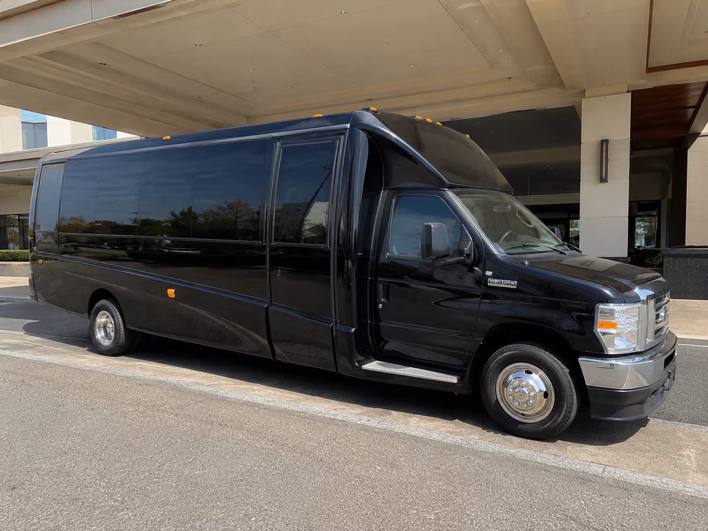 Group beside a Mercedes Sprinter limo in Kansas City